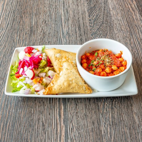 Rangoli Restaurant, two crispy golden samosas served with spicy chickpea curry in East Kilbride. 